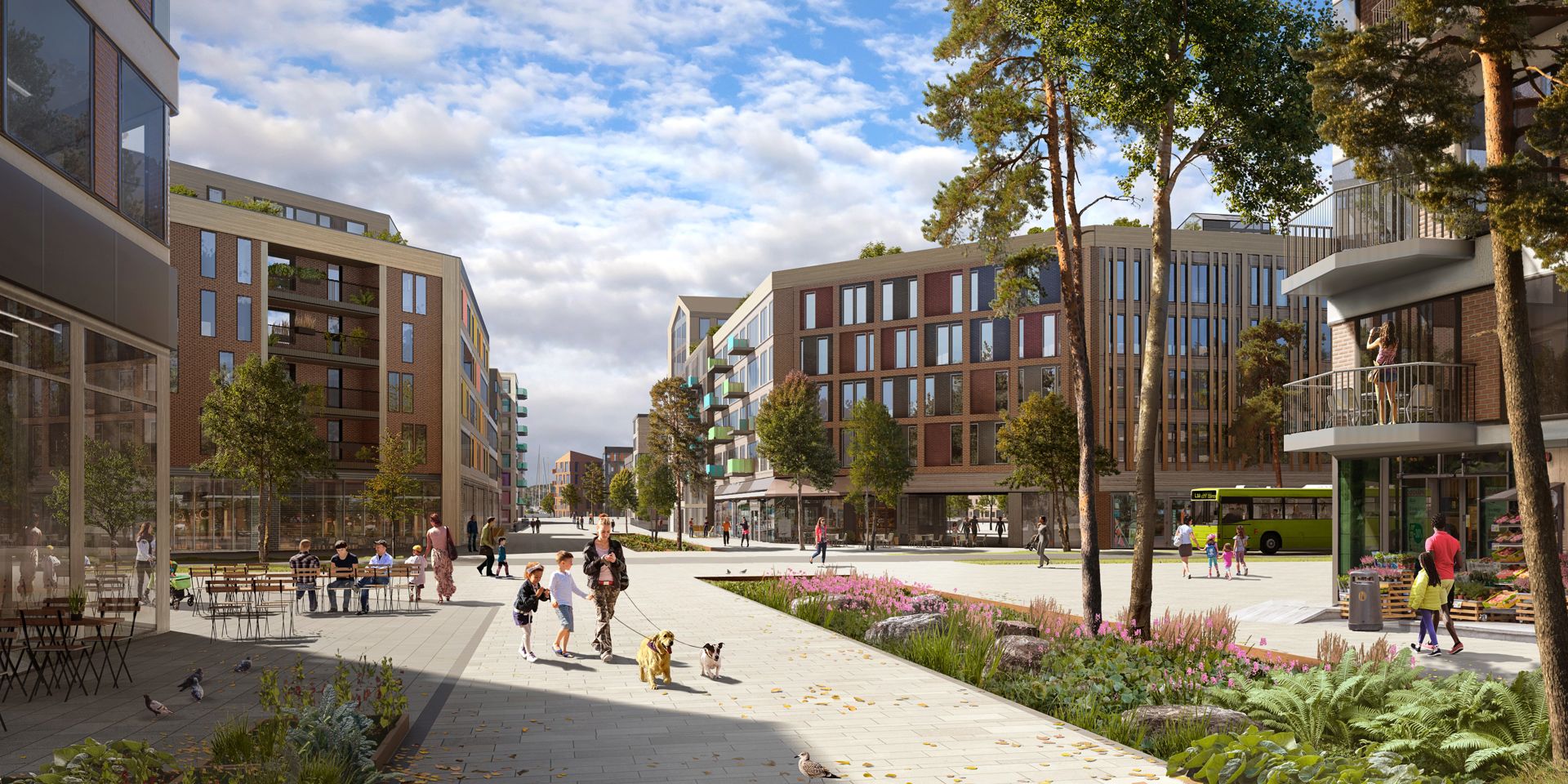 Trær, grøntområder og bygg omkranser torget der mennesker oppholder seg.